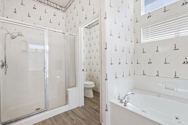 bathroom with toilet, wallpapered walls, a garden tub, and a stall shower