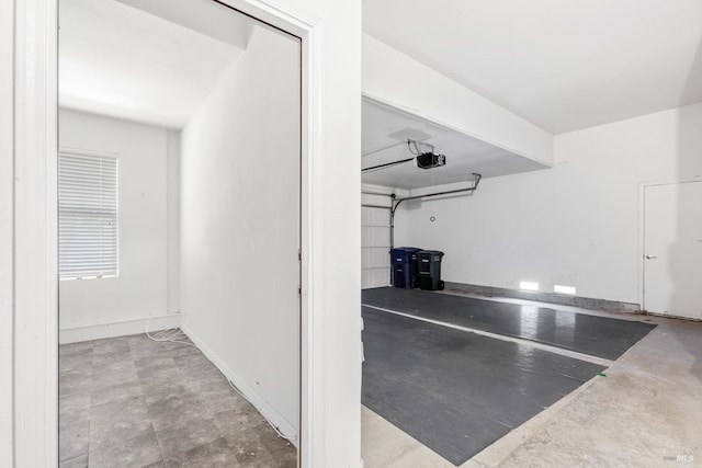 garage featuring baseboards and a garage door opener