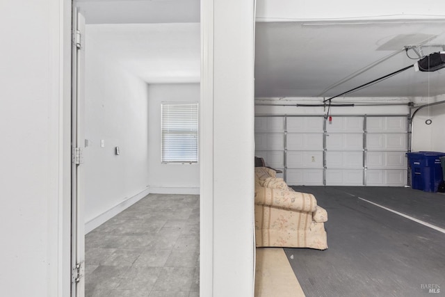 garage featuring baseboards and a garage door opener