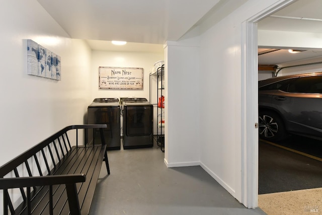 hall with washer and dryer and concrete floors