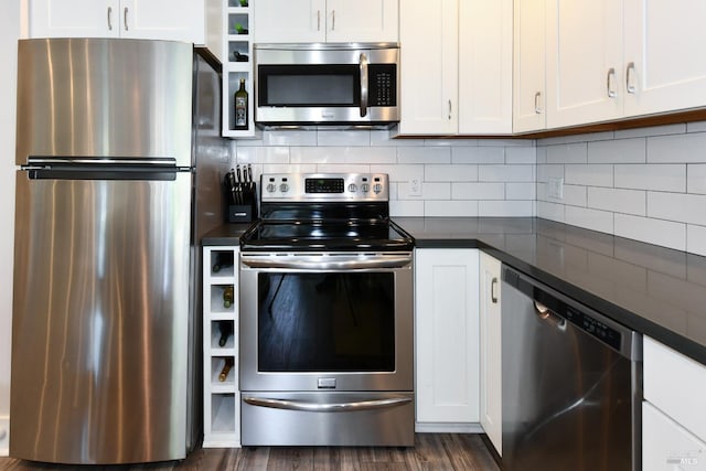 kitchen featuring backsplash, dark hardwood / wood-style flooring, white cabinetry, and stainless steel appliances