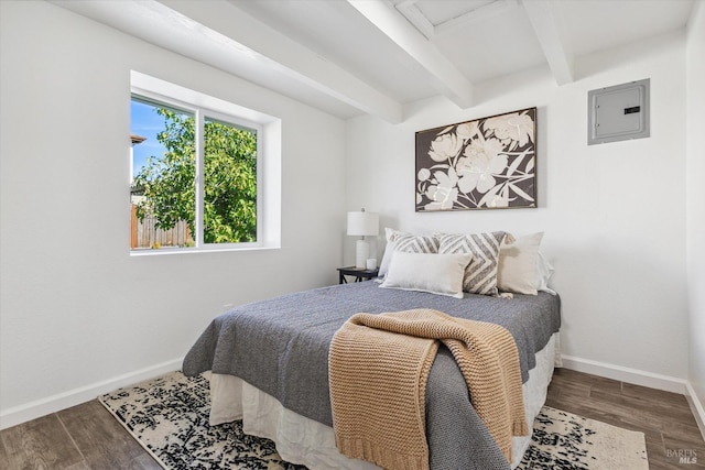 bedroom with beamed ceiling, hardwood / wood-style flooring, and electric panel