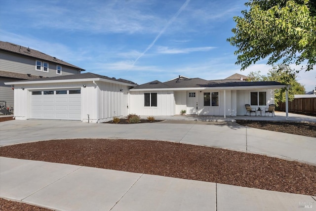 view of front of house with a garage and a patio