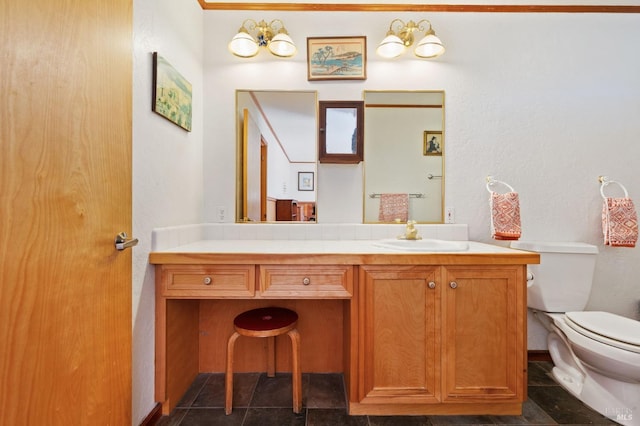 bathroom with toilet, a chandelier, and vanity