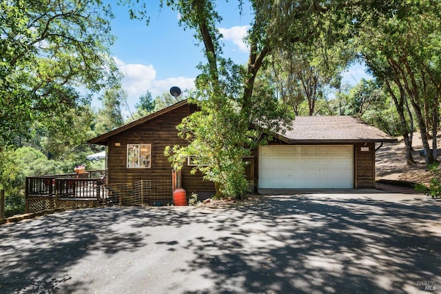 view of front of house with a garage and a deck