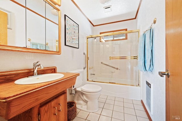 full bathroom featuring tile patterned floors, vanity, bath / shower combo with glass door, toilet, and ornamental molding