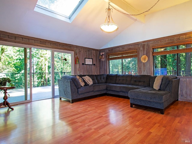 living room with a skylight, a healthy amount of sunlight, and wood-type flooring