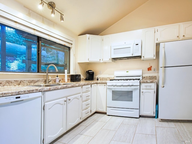 kitchen with white cabinets, white appliances, lofted ceiling, and sink