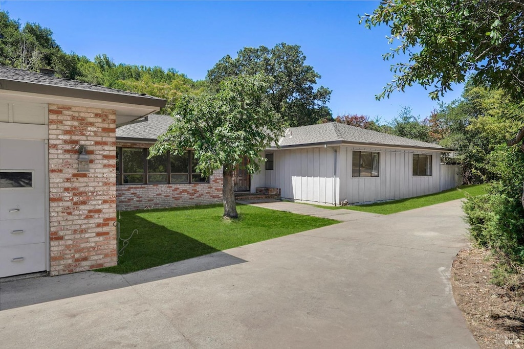 view of front of property with a garage and a front lawn