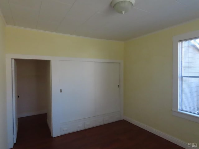 unfurnished room featuring crown molding and dark hardwood / wood-style floors