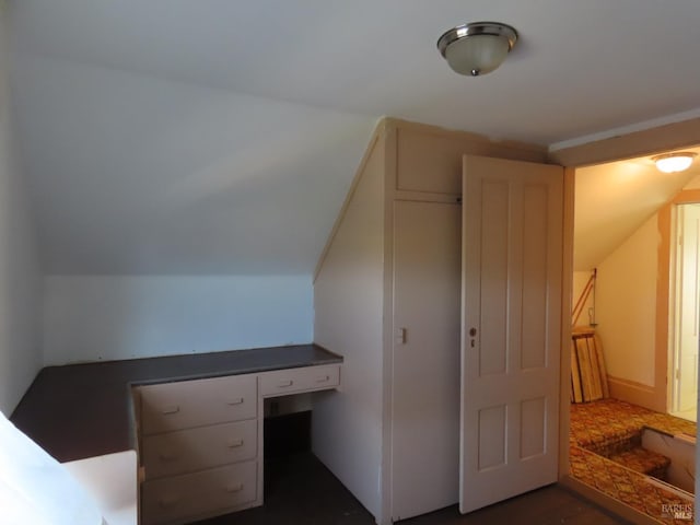 bonus room with built in desk and lofted ceiling