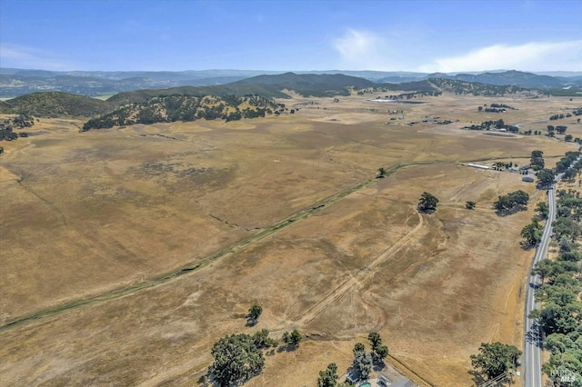 drone / aerial view with a mountain view and a rural view