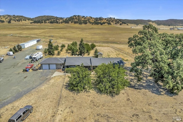 birds eye view of property featuring a mountain view and a rural view