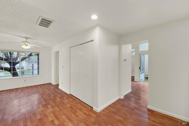 spare room with light hardwood / wood-style flooring and ceiling fan