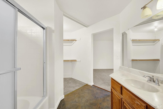 bathroom with vanity and combined bath / shower with glass door