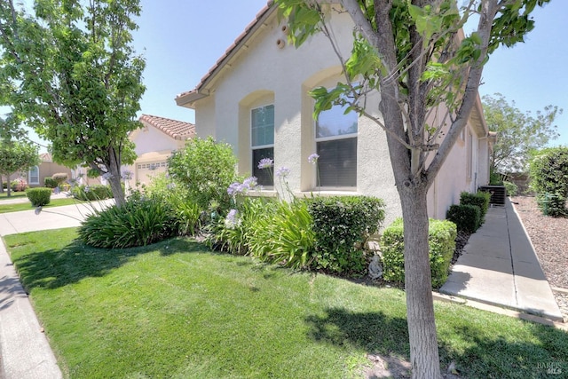 view of home's exterior with a lawn