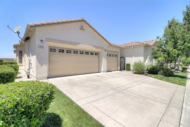 mediterranean / spanish-style home with a garage