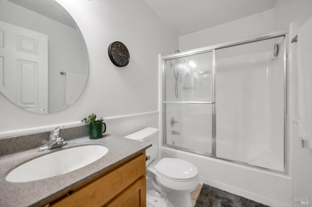 full bathroom featuring shower / bath combination with glass door, vanity, and toilet