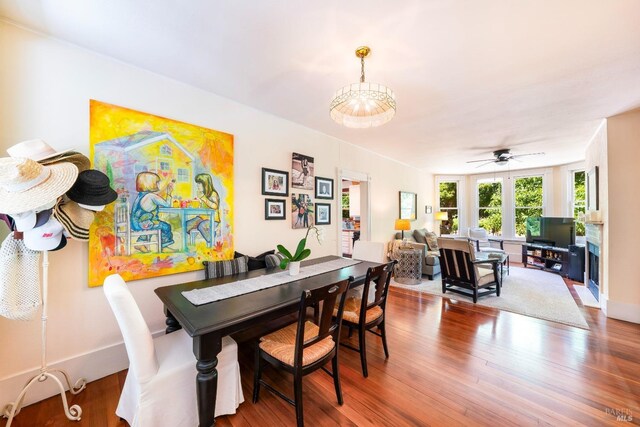 dining area featuring hardwood / wood-style flooring and ceiling fan