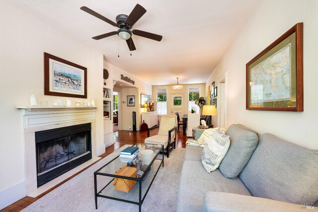 living room with hardwood / wood-style flooring and ceiling fan