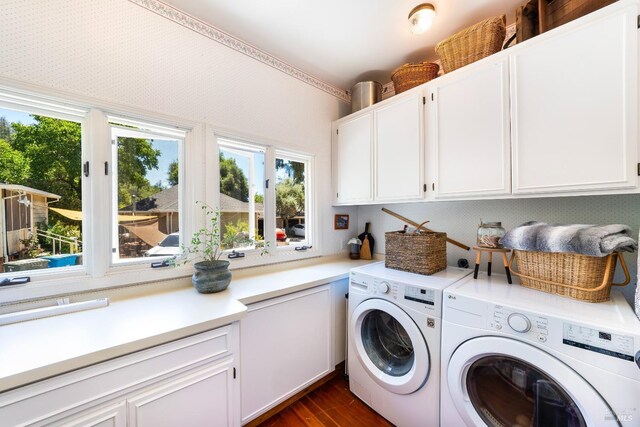 washroom with cabinets, dark wood-type flooring, and washer and clothes dryer