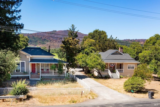 bungalow-style home featuring a mountain view and covered porch