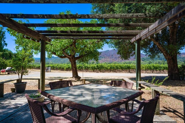 view of patio featuring a pergola and a deck with mountain view