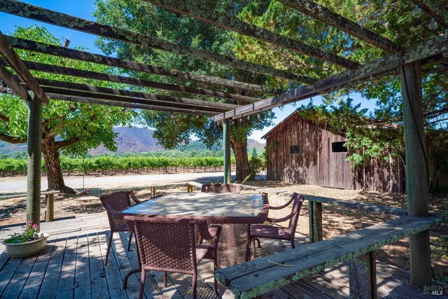 wooden deck featuring a pergola and a mountain view