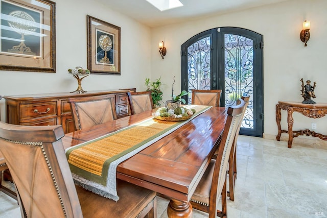 dining room featuring a skylight