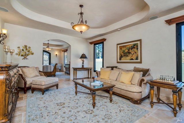 living room with a tray ceiling