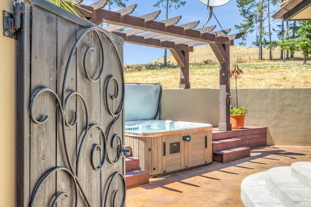 view of patio featuring a hot tub and a pergola