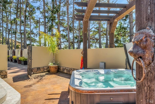 view of patio / terrace with a hot tub and a pergola