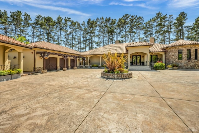 mediterranean / spanish-style home with a garage