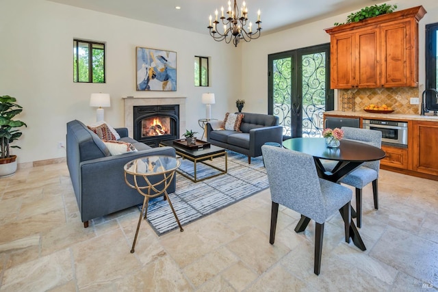 living room with french doors and a chandelier