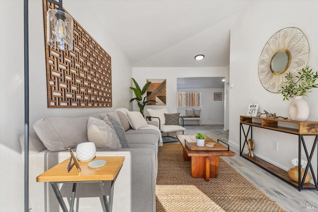 living room with hardwood / wood-style flooring and vaulted ceiling