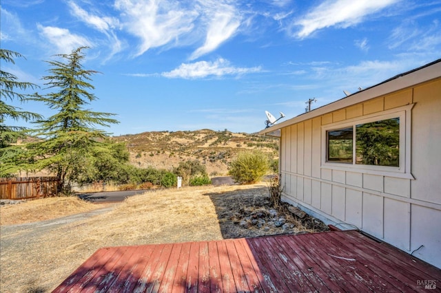 deck featuring fence and a mountain view