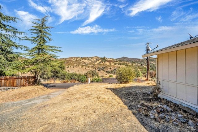 view of yard with a mountain view and fence