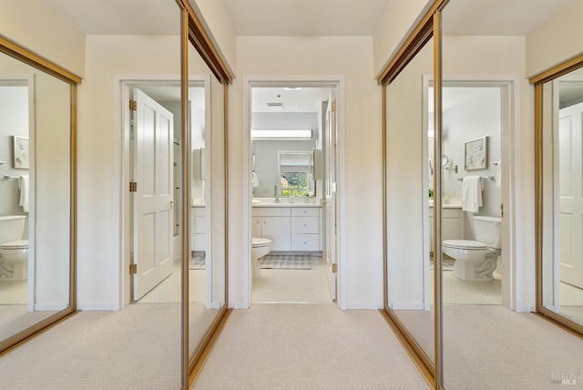 hall featuring light colored carpet