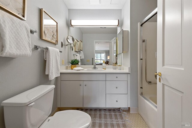 bathroom featuring shower / bath combination with glass door and vanity