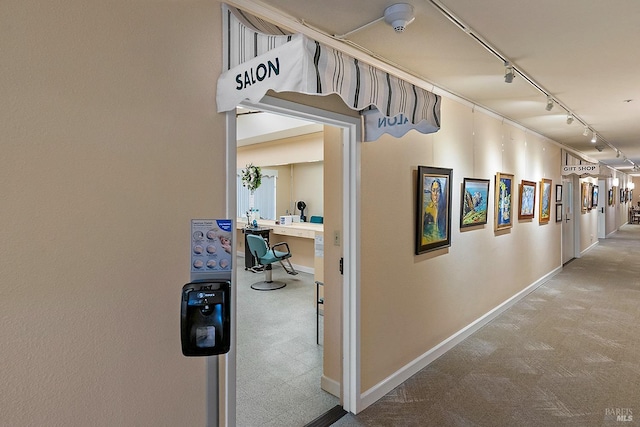 hallway featuring carpet and rail lighting