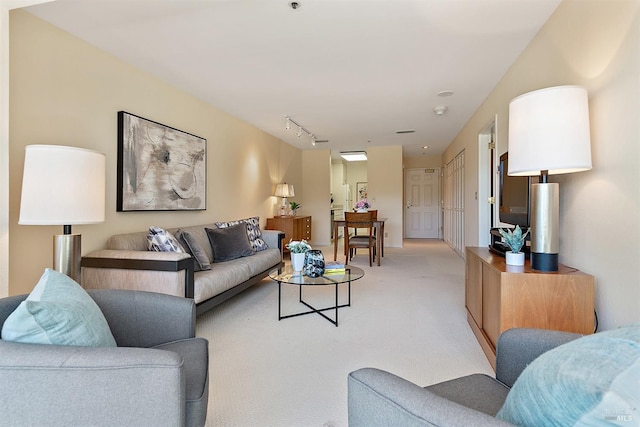 carpeted living room featuring rail lighting