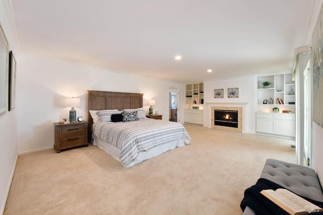 bedroom with light colored carpet and a fireplace