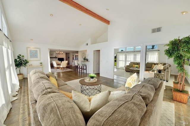 tiled living room with beamed ceiling, an inviting chandelier, and high vaulted ceiling