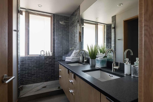 bathroom with vanity and tiled shower