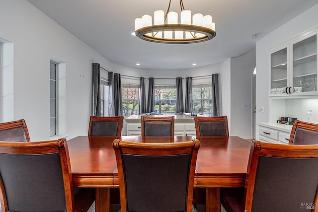 dining space featuring recessed lighting and an inviting chandelier