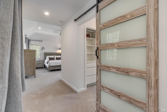 interior space with recessed lighting, light carpet, baseboards, and a barn door
