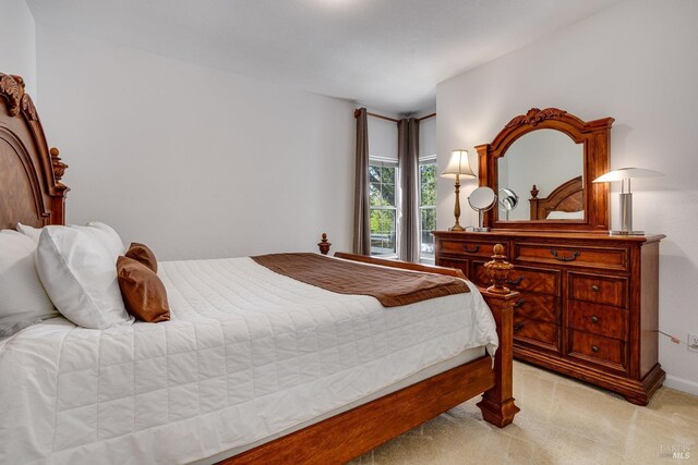 bedroom featuring light carpet