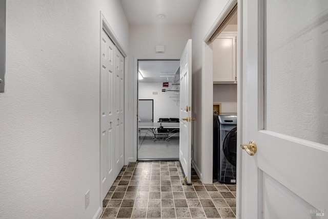 hall with washer / clothes dryer