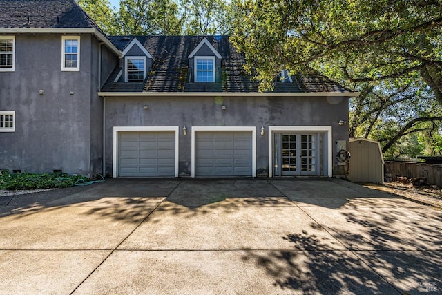 garage with french doors and driveway