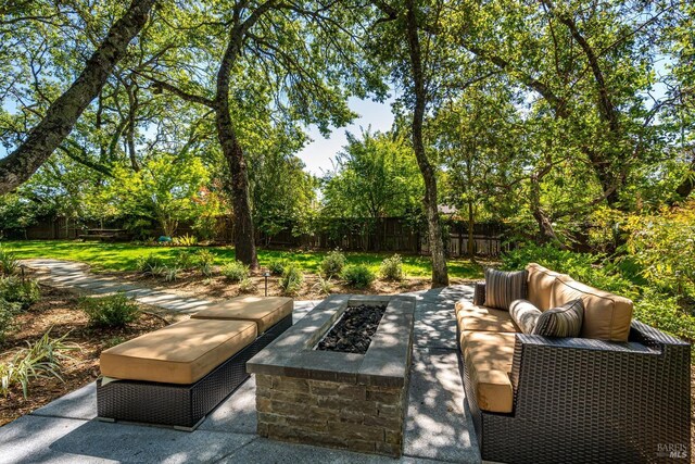view of patio / terrace with an outdoor fire pit and a fenced backyard